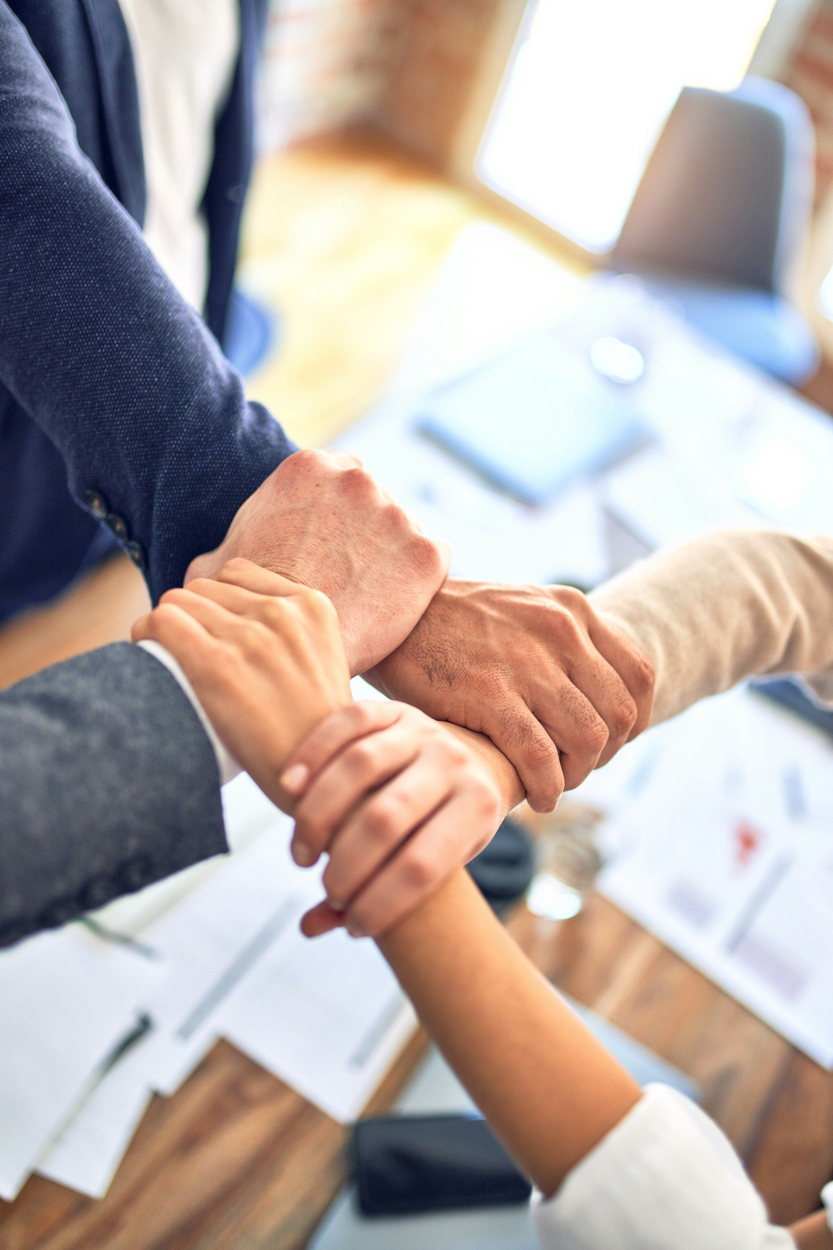 Hands joined showing unity and success